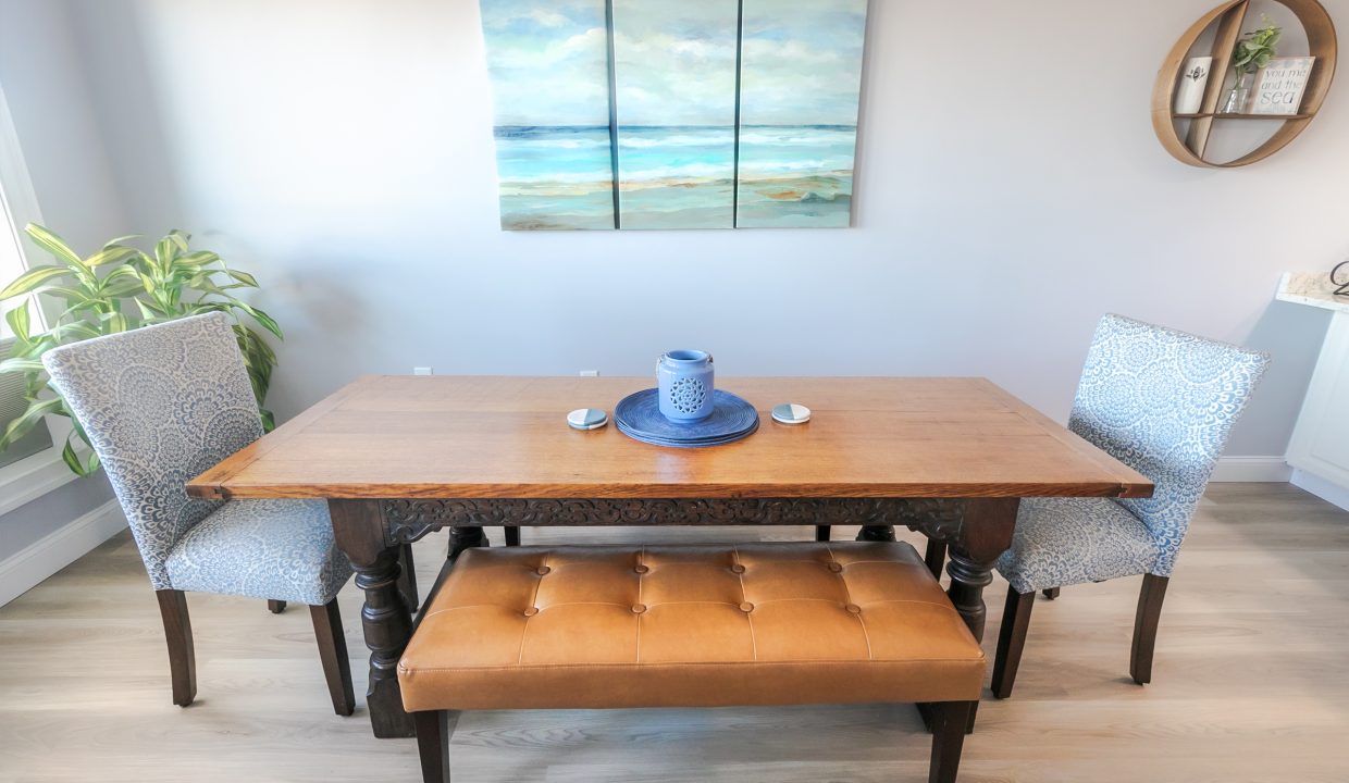 A table with a blue plate and two chairs.