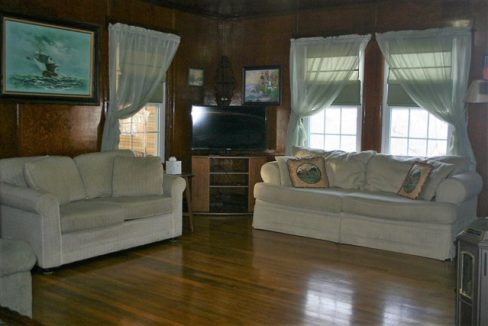 A living room with two couches and a tv.