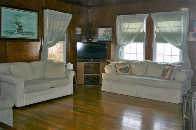 A living room with two couches and a tv.