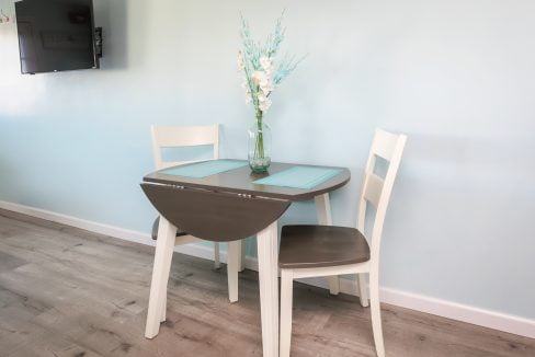 A small table and chairs in a room with blue walls.