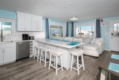 A kitchen with blue walls and white counter tops.