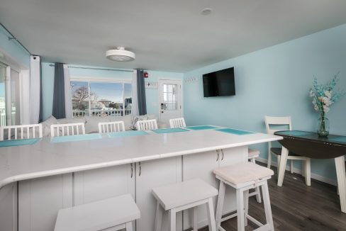 A kitchen with blue walls and white counter tops.