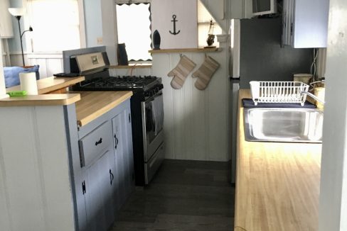 A kitchen in a tiny house with a stove and sink.