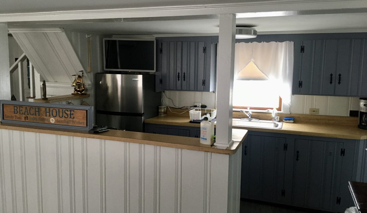 A kitchen with a stove and refrigerator.