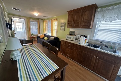 A kitchen with a table and chairs and a refrigerator.