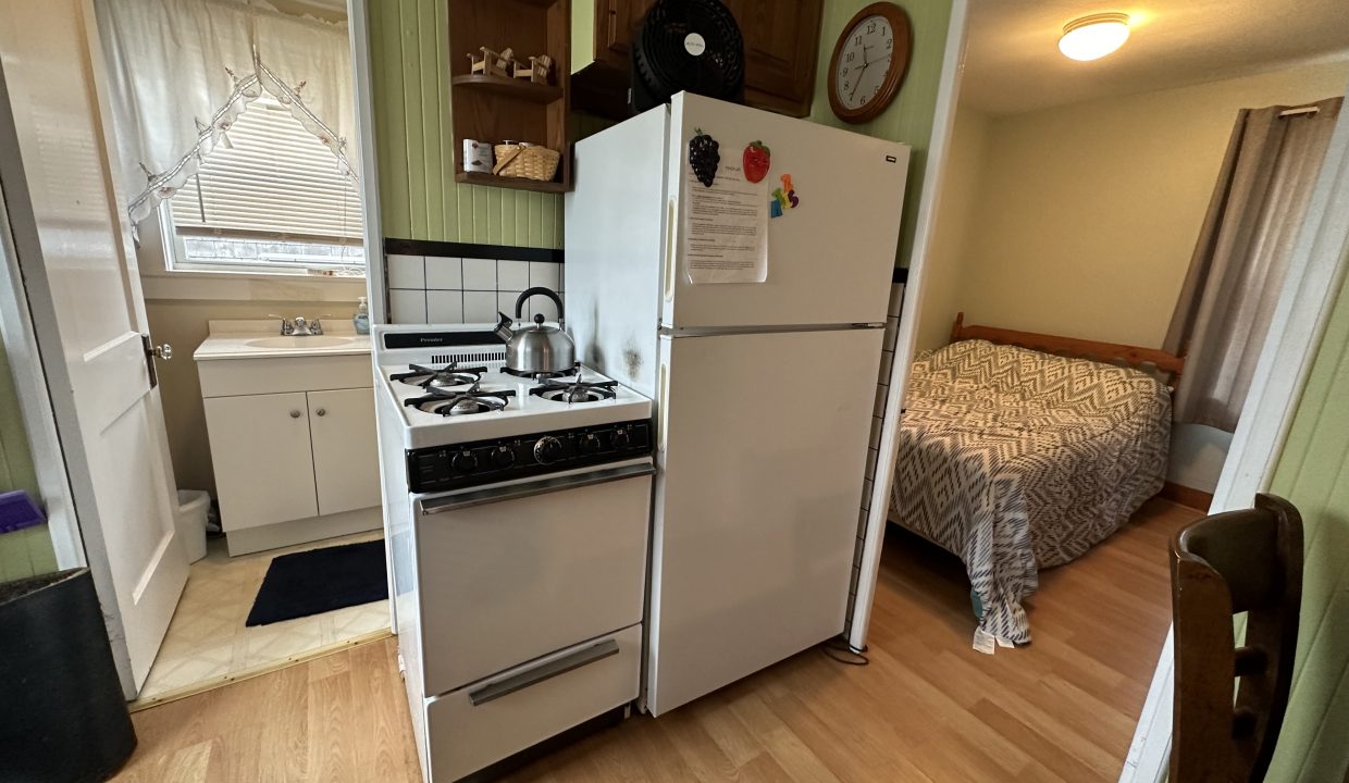 A small kitchen with a stove and refrigerator.