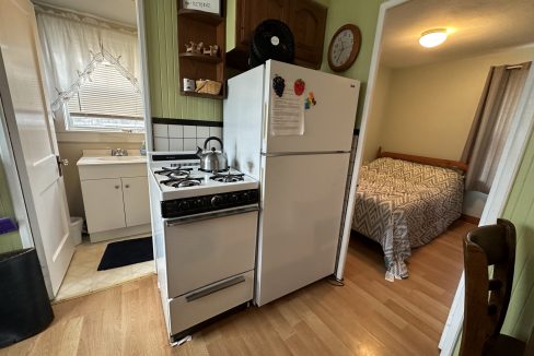 A small kitchen with a stove and refrigerator.