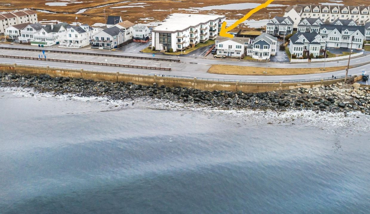 A group of buildings next to a body of water.