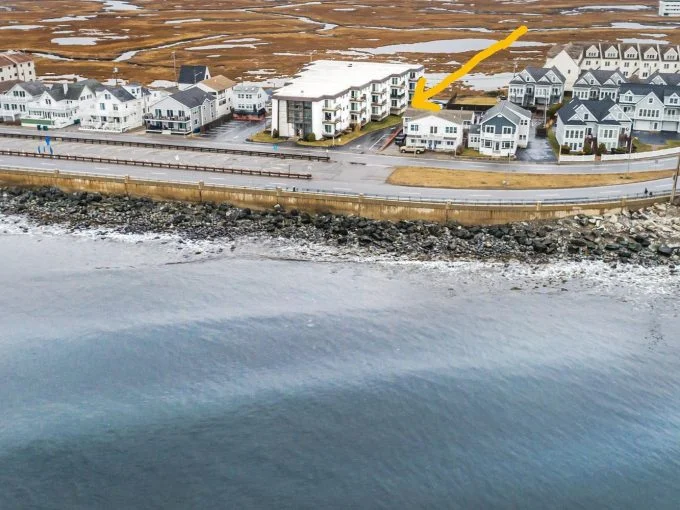 A group of buildings next to a body of water.