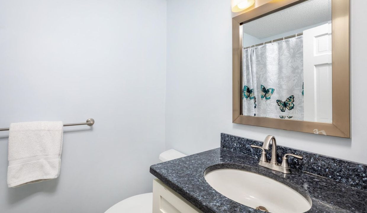 A bathroom with a mirror and sink.