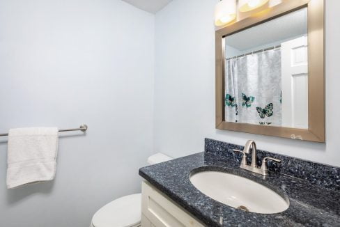 A bathroom with a mirror and sink.