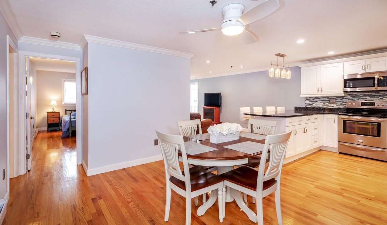 A dining table and kitchen in a house.