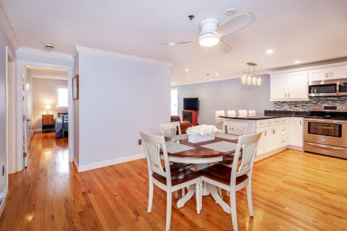 A dining table and kitchen in a house.