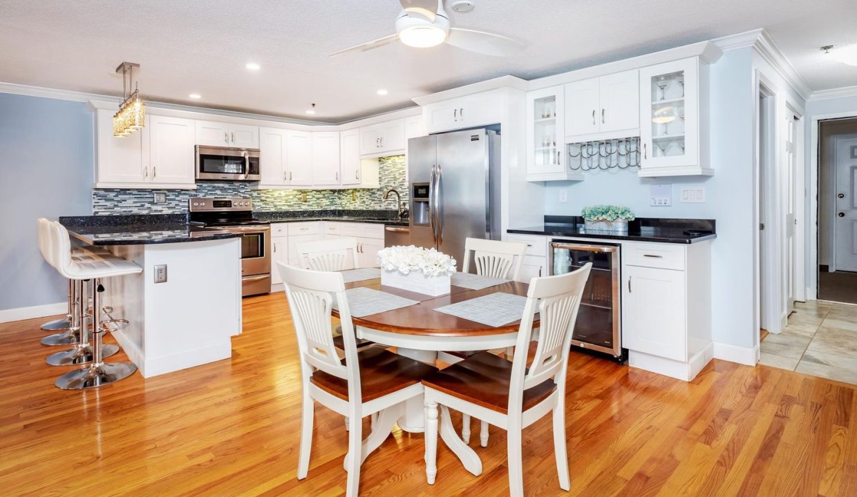 A kitchen with white cabinets and a table.