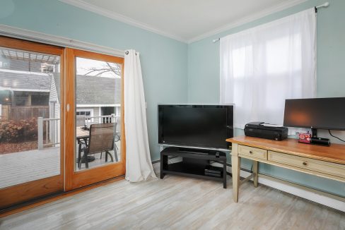 A small room with a television and a desk.