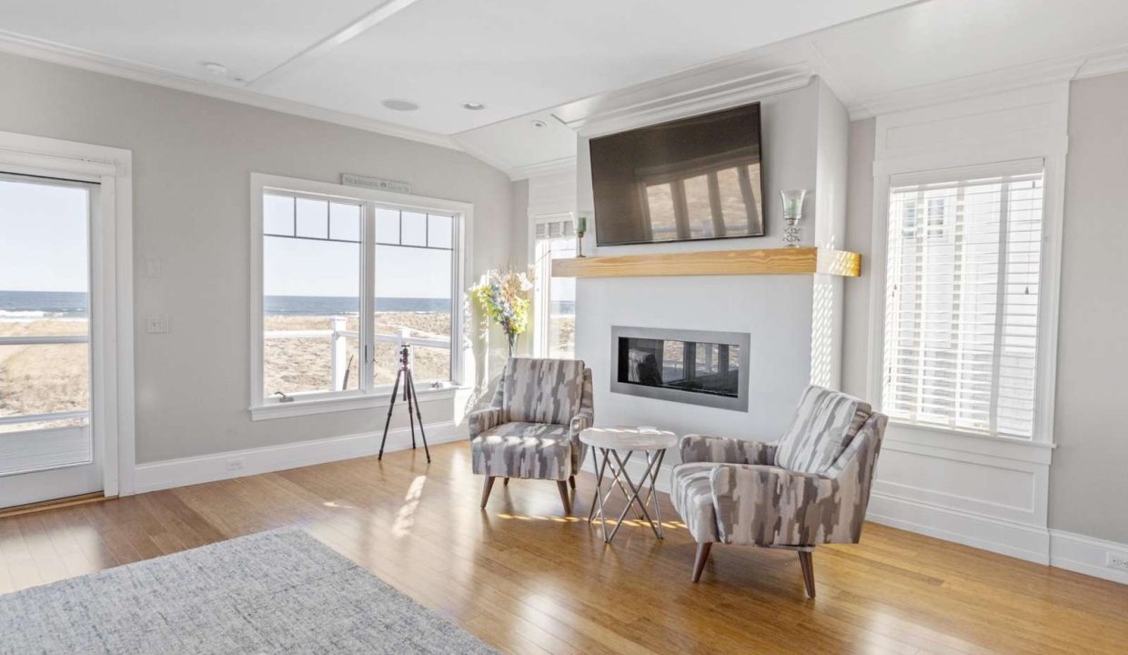 Cozy living room with a fireplace and ocean view.