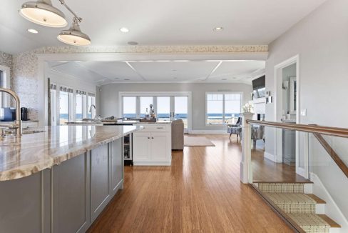 A spacious kitchen with modern appliances and an ocean view.