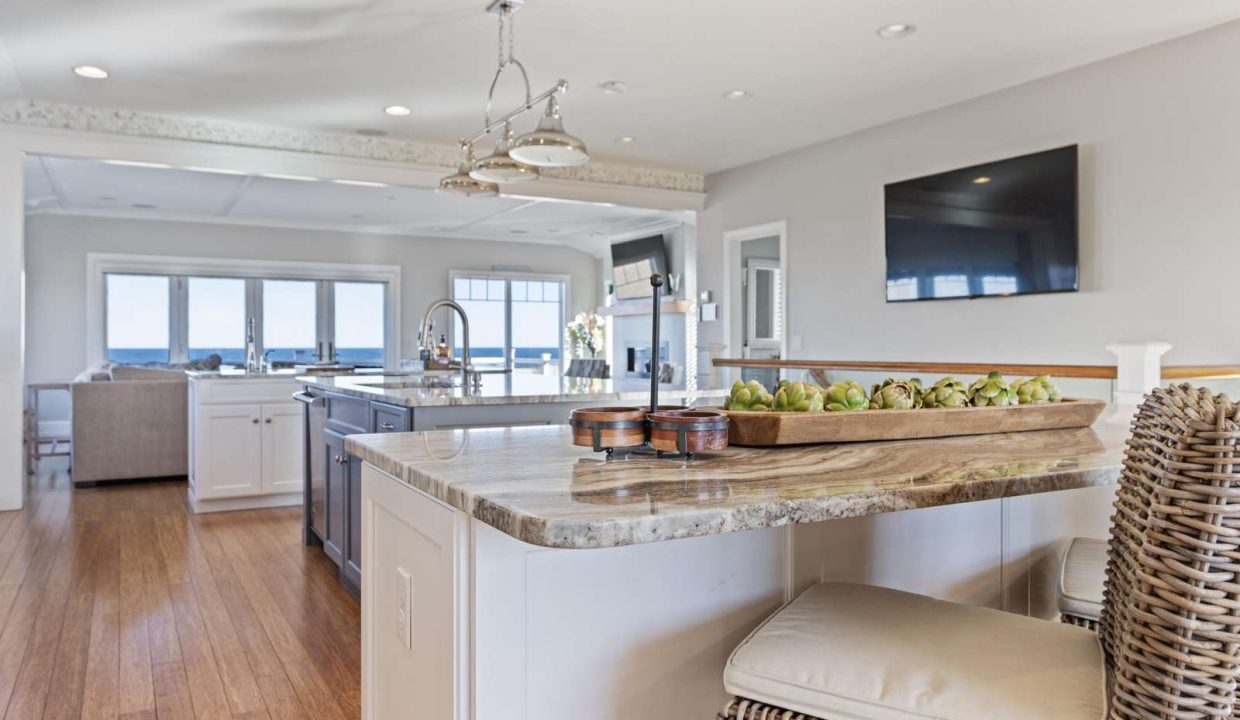 Spacious modern kitchen with a large island, granite countertops, and ocean views.