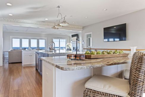 Spacious modern kitchen with a large island, granite countertops, and ocean views.