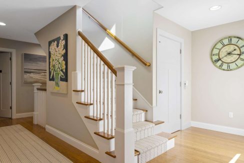 Modern home interior with wooden staircase and neutral color palette.