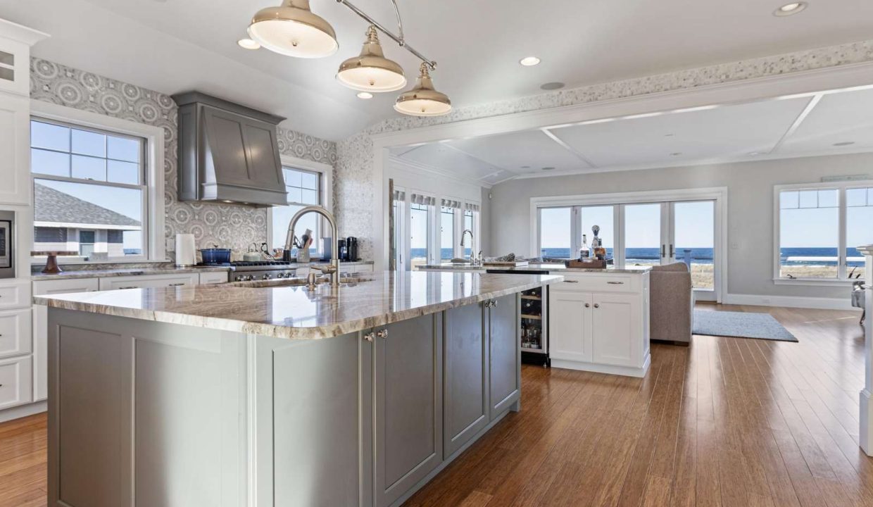 Spacious modern kitchen with an island, granite countertops, and an ocean view.