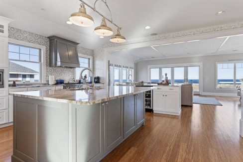 Spacious modern kitchen with an island, granite countertops, and an ocean view.